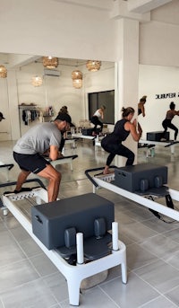 a group of people doing pilates in a gym