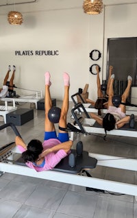 People doing reformer pilates in playa del carmen with a pilates ball