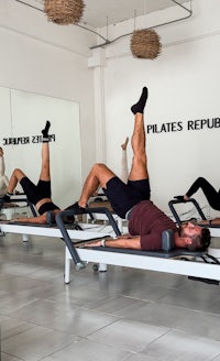 a group of people doing pilates in a gym